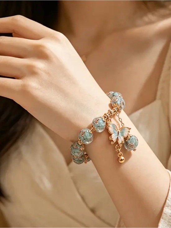 The Unbranded Brand Jewelry - Gold Butterfly Charm Blue Floral Bracelet.